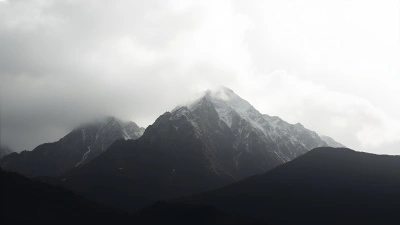 Black and White Mountain Range With Bright Sky