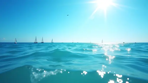 Blue Ocean Waves With Sailboats Under Sunny Sky