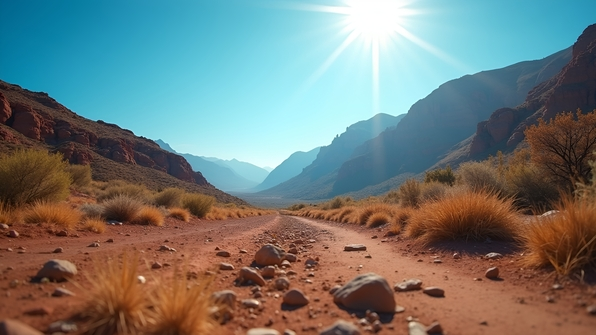 High-resolution daytime photograph of a brown mountain landscape under a clear blue sky with natural sunlight and minimal vegetation