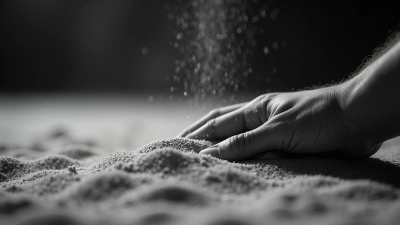 Close-Up of Hand Spreading Fine Sand