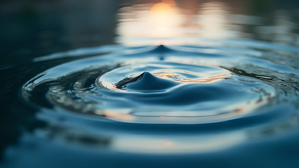 Close-up of delicate water ripples on a calm surface with soft reflections and natural lighting