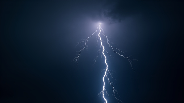 A dramatic lightning bolt illuminates a dark, stormy black sky with vivid, jagged electric branches striking downward