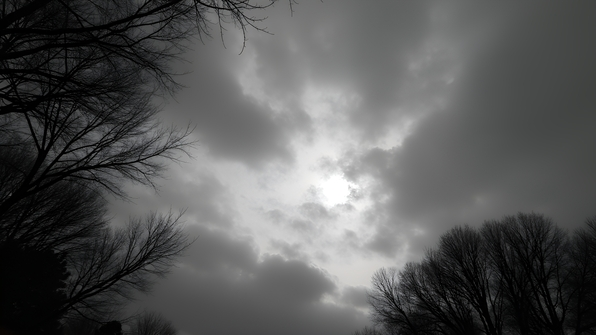 Dramatic textured clouds swirling across a moody overcast sky in black and white