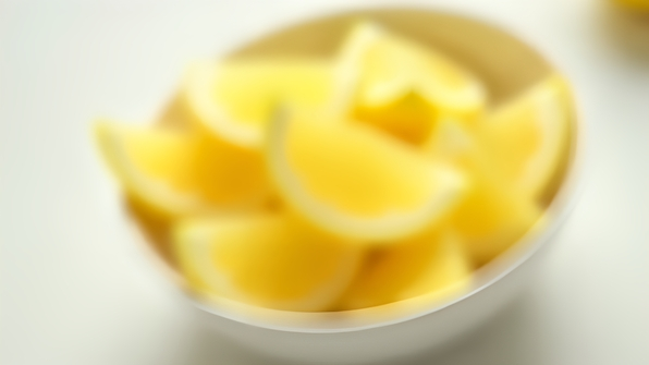 Fresh Lemon Sliced Thin Wedges In White Bowl