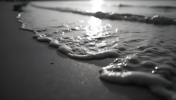 Gentle Water Ripples On Textured Beach