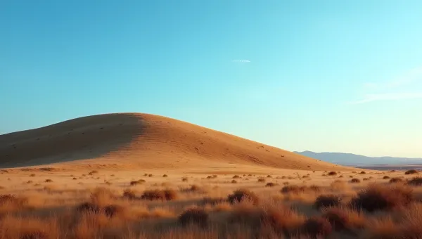 Gently Sloping Brown Hill Under Blue Sky