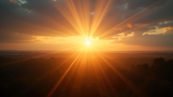 Golden crepuscular rays streaming through scattered clouds over a serene forest landscape at sunset