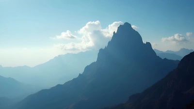 Jagged Mountain Peaks Silhouette Against Blue Sky