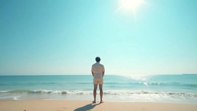 Man on Sandy Beach Facing Calm Ocean