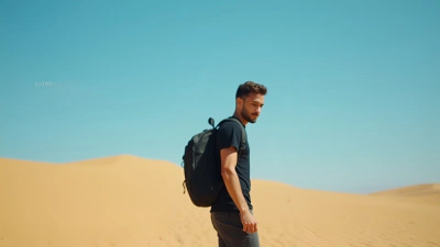Man Wearing Black T-Shirt On Golden Sand