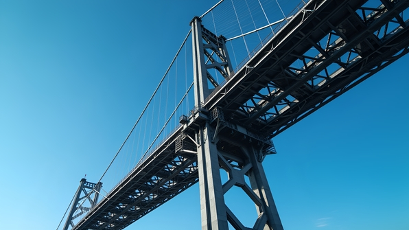 High-resolution architectural photograph of a modern steel bridge with geometric design and sleek lines against a clear blue sky