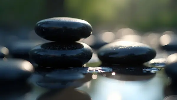 Polished Black Stones Close-Up On Reflective Surface