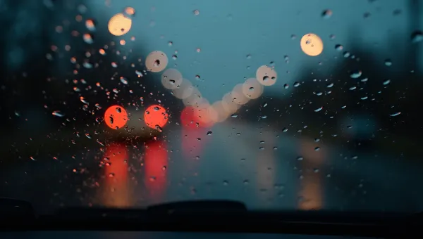 Rain Droplets Streaming Down Car Window