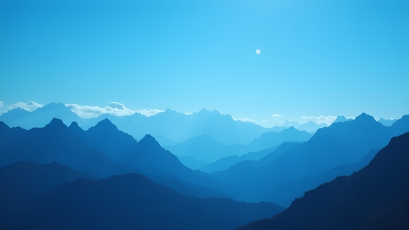 Silhouette of rugged mountain peaks sharply outlined against a clear, vibrant blue sky with soft white clouds