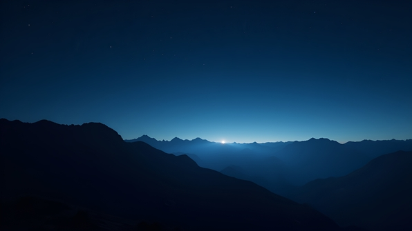 Silhouette of a rugged mountain range beneath a clear, star-filled night sky with twinkling stars and a subtle glow on the horizon