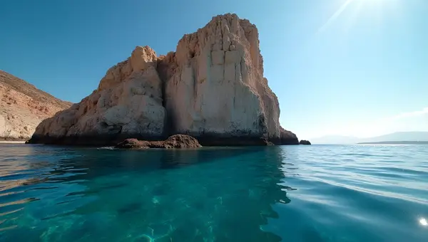 Rugged Rock Formation Over Clear Blue Water