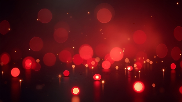 Close-up of shimmering red and white bokeh lights softly glowing against a dark blurred background