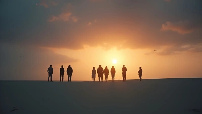 Silhouetted Figures On Smooth Gray Sand Under Moody Sky