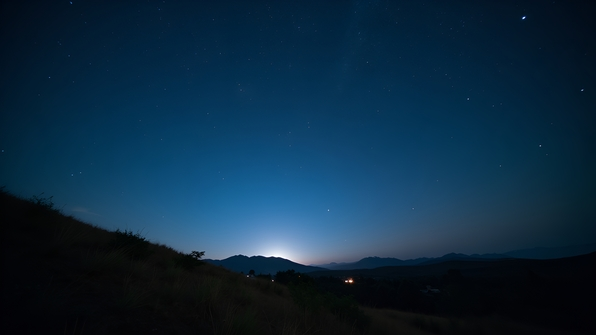 Star-filled night sky with twinkling stars over a serene natural landscape