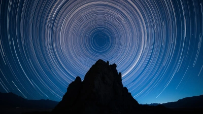 Star Trails Over Jagged Rock Silhouette At Night