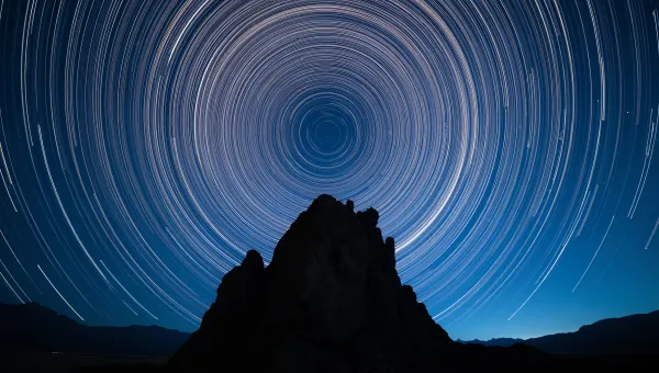Star Trails Over Jagged Rock Silhouette At Night