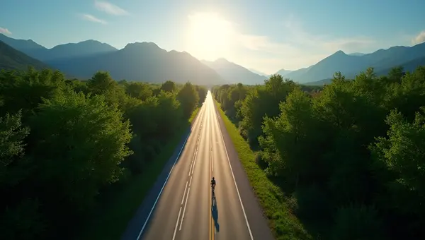 Straight Asphalt Road Through Green Trees