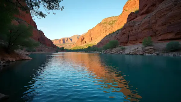 Sunlit Brown Rock Formation by Calm Blue Lake