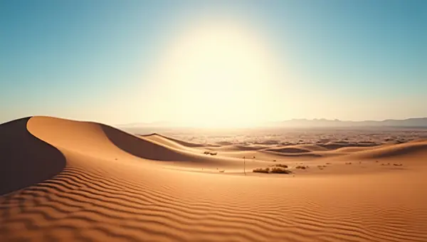 Sunlit Sand Dunes Under Clear Blue Sky