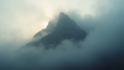 Towering Mountain in Dense Fog Under Soft Daylight