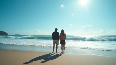 Two People on Sandy Seashore Watching Ocean Waves