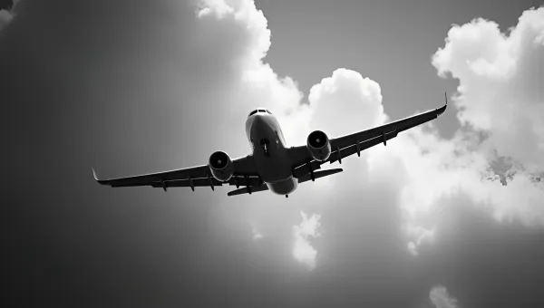 Vintage Airplane Soaring Against Cloudy Sky