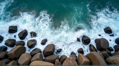 Aerial View Foamy Sea Surging Granite Boulders