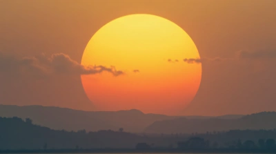 Amber Sun Rising Over Rolling Hills