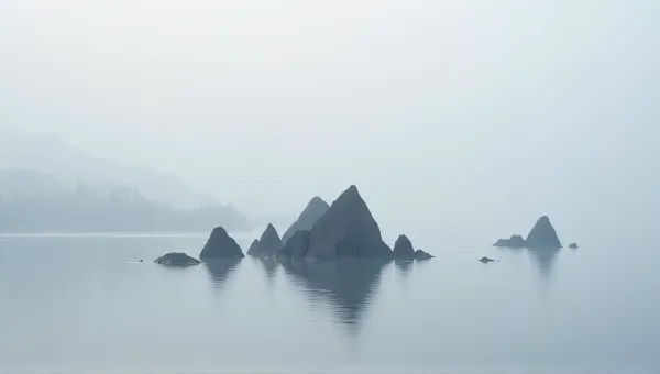 Angular Stone Structures Reflecting On Lake