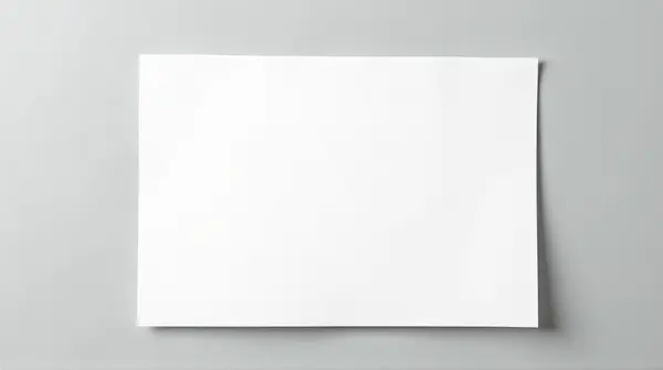 Single blank printer paper sheet lying flat on a smooth surface seen from above.