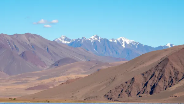 Brown Mountain Range Under Clear Blue Sky
