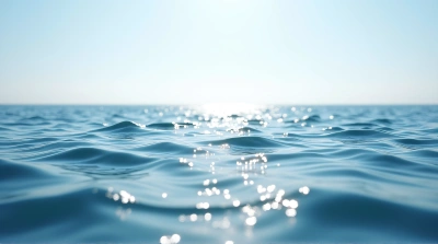 Calm Lake With Rippling Shoreline Under Blue Sky