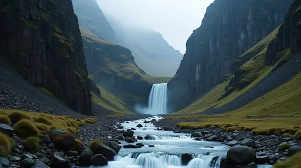 Cascading stream flowing through jagged cliffs and a narrow deep valley from a low angle view