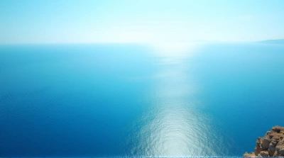 Cerulean Sea From Coastal Cliff Under Bright Sky