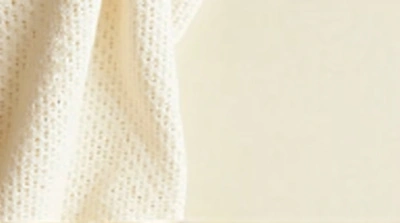 Close-Up Woven Textile Against Ivory Wall
