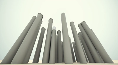 Cluster Of Cylindrical Trunks Against Pale Sky