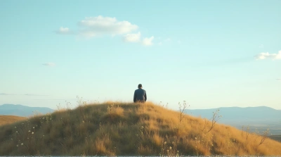 Contemplative Figure Sitting on Gentle Slope Outdoors