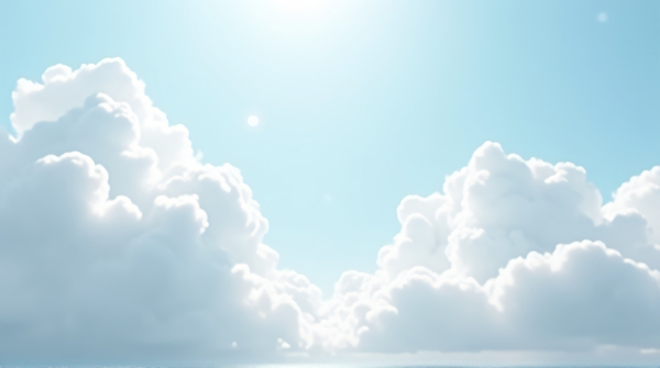Soft cumulus clouds spread across a pale azure sky gently lit by sunlight from above.