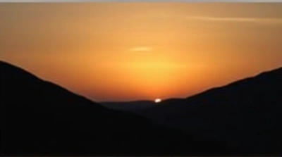 Dark Ridge Against Glowing Horizon At Dusk