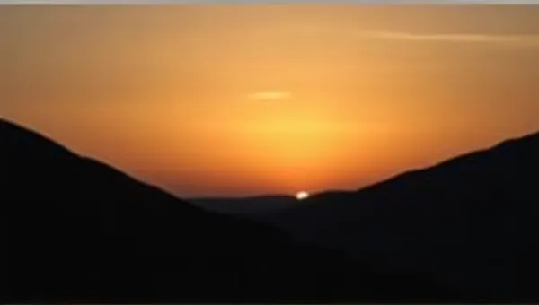 Dark Ridge Against Glowing Horizon At Dusk