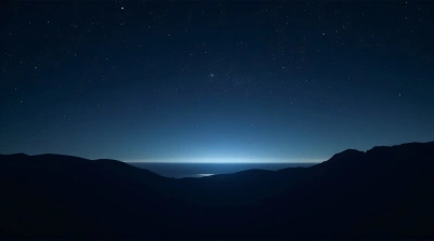 Dark Ridge Silhouettes Against Starry Night Sky