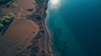 Dark Sediment Meeting Deep Blue Lake Surface