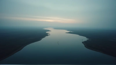 Dark Water Body With Faint Shorelines At Dusk