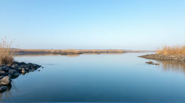 Deep Blue Water Surface Near Rocky Shoreline