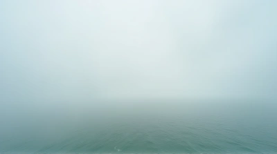 Expansive Blue-Green Sea Horizon With Soft Vapor